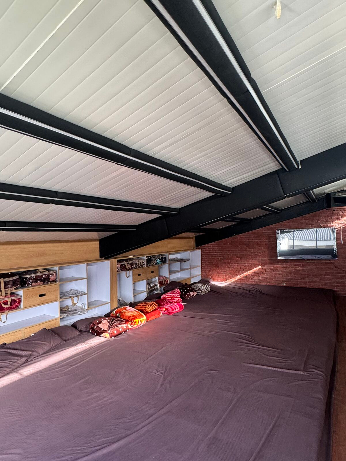 Attic dormitory space that sleeps large groups under exposed beams