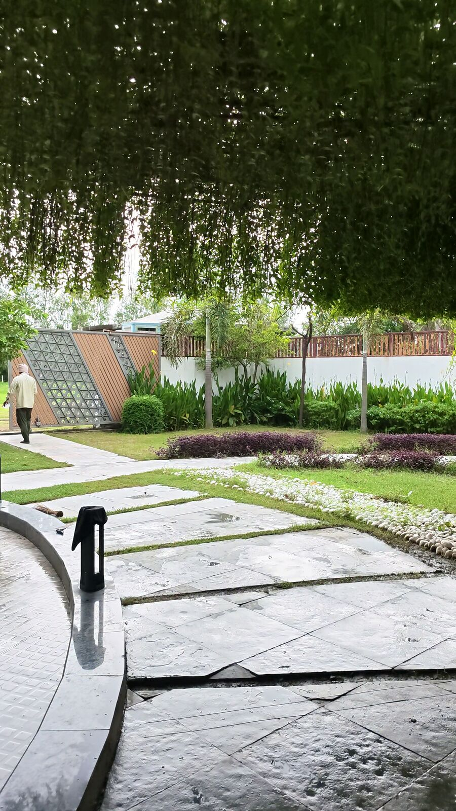 Manicured lawn with vertical garden wall and flower beds