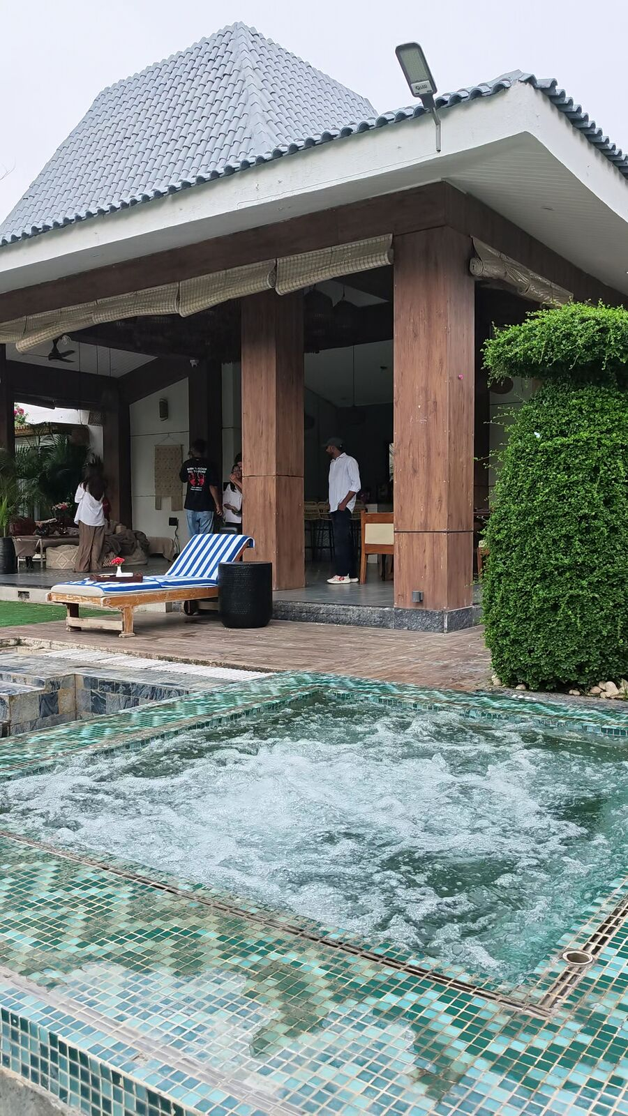 Bubbling open-air jacuzzi beside the Bali-style poolside pavilion