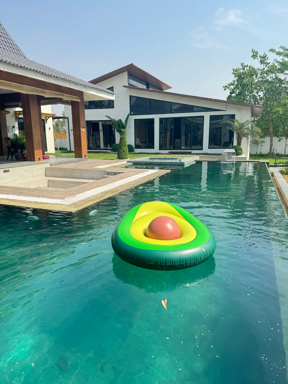 Private pool with an avocado float on a sunny day at Urban Euphoria